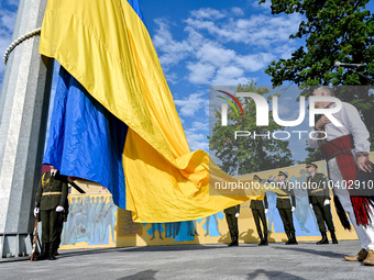 LVIV, UKRAINE - AUGUST 23, 2023 - Honour guards hoist a 25m flag of Ukraine outside the Hetman Petro Sahaydachnyi National Army Academy on N...