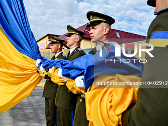 LVIV, UKRAINE - AUGUST 23, 2023 - Honour guards hoist a 25m flag of Ukraine outside the Hetman Petro Sahaydachnyi National Army Academy on N...