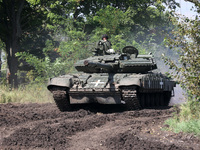 KHARKIV REGION, UKRAINE - AUGUST 16, 2023 - A serviceman stands in a hatch of a tank as the military personnel of the 41st Separate Mechaniz...