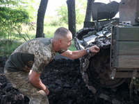 KHARKIV REGION, UKRAINE - AUGUST 16, 2023 - A serviceman repairs a tank as the military personnel of the 41st Separate Mechanized Brigade of...