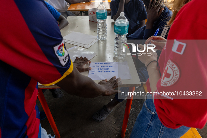 Italian lessons were held inside the camp.  Migrants coming from Lampedusa are hosted by Torino Hub, a first reception center managed by the...