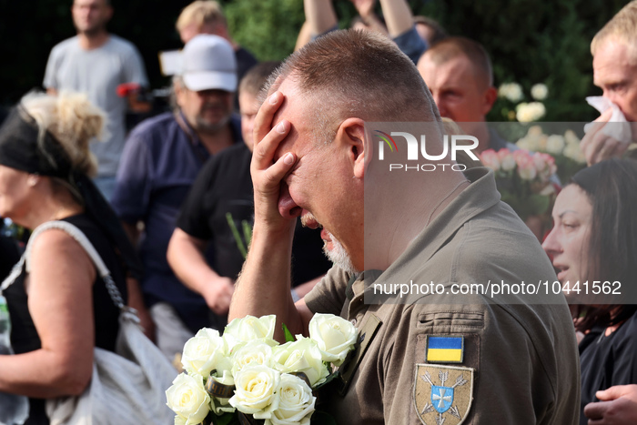 POLTAVA, UKRAINE - SEPTEMBER 1, 2023 - A man cries during the funeral ceremony of pilots and technicians of two Mi-8 helicopters outside the...