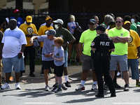 Participants of the Tri-State Labor Day Parade wait for the presidential motorcade to pass before marching along Christopher Columbus Boulev...