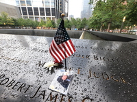 Flowers and US flags are laid on one of the South Pool panels at World Trade Center Memorial to commemorate the 9/11 Anniversary in New York...