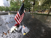 Flowers and US flags are laid on one of the South Pool panels at World Trade Center Memorial to commemorate the 9/11 Anniversary in New York...