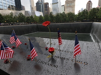Flowers and US flags are laid on one of the North Pool panels at World Trade Center Memorial to commemorate the 9/11 Anniversary in New York...