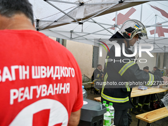 LVIV, UKRAINE - SEPTEMBER 19, 2023 - State Emergency Service employees have dinner during a response effort to the Russian drone strike at i...