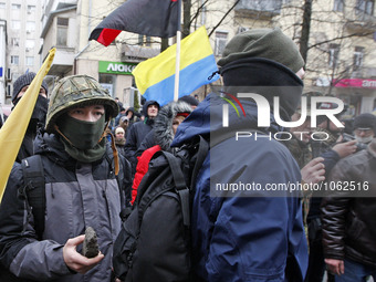 Ukrainian radical protestors throws a stones at the office of a bank 