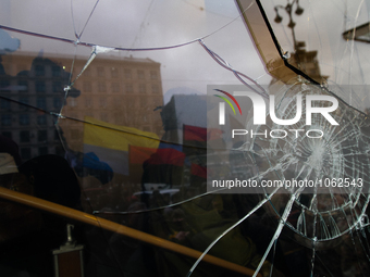 A map cracking is seen on the windows of russian Alfa-Bank office downtown Kyiv after Ukrainian radical protesters threw stones during their...