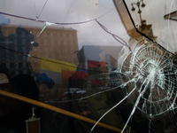 A map cracking is seen on the windows of russian Alfa-Bank office downtown Kyiv after Ukrainian radical protesters threw stones during their...