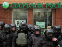 Special police forces and National Guards are seen patrolling the street next to the Sberbank of Russia office as radical nationalists prote...