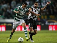 Sporting's midfielder Ezequiel Schelotto (L) vies for the ball with Boavista's defender Ruben Ribeiro (R)  during the Portuguese League  foo...