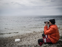 A volunteer looking for incoming boats with Migrants in Mytilene, island of Lesbos, Greece, on February 24, 2016. More than 110,000 migrants...
