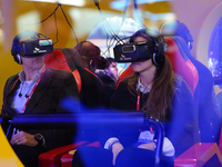 A congress attendants reacting to VK Telecom virtual 360 glasses , during the last  day of Mobile World Congress in Barcelona, 24th of Febru...