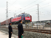 Station staff command the first JSQ commercial train of the first China-Europe freight train in the evening of November 13, 2023 in Chongqin...