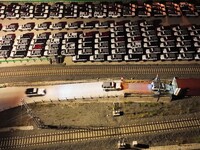 Workers drive Great Wall Tank 300 off-road vehicles onto a JSQ commercial vehicle, the first China-Europe freight train, in Chongqing, China...
