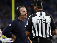 Chicago Bears head coach Matt Eberflus talks to side judge David Meslow during the first half of an NFL football game between the Chicago Be...