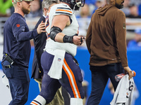 Chicago Bears guard Lucas Patrick (62) is assisted off the field after being checked for an injury during  an NFL  football game between the...