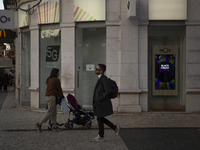 People are walking by stores with ''Black Friday'' promotions in Portugal on November 25, 2023. The economic boost during Black Friday week...