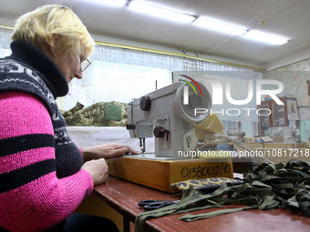 A volunteer is operating a sewing machine as the Combat Toloka Volunteer Centre makes camouflage nets, clothes, and gear for the Ukrainian m...