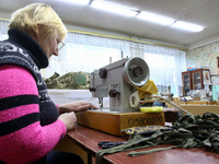A volunteer is operating a sewing machine as the Combat Toloka Volunteer Centre makes camouflage nets, clothes, and gear for the Ukrainian m...