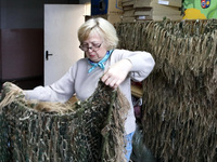 Nadiia Lystopad, the founder of the Combat Toloka Volunteer Centre, is showing a ghillie suit made by volunteers for the Ukrainian military...