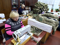 Women are operating sewing machines at the Combat Toloka Volunteer Centre, which is making camouflage nets, clothes, and gear for the Ukrain...