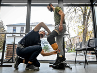 A prosthetist, Oleksii Yatsenko (L), is helping serviceman Andrii with the fitting of a prosthetic leg at the Prosthetics and Rehabilitation...