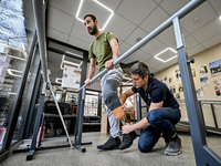 Prosthetist Oleksii Yatsenko (R) is helping serviceman Andrii with the fitting of a prosthetic leg at the Prosthetics and Rehabilitation Cen...