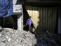 A Palestinian is walking amid the rubble of destroyed buildings in the Bureij camp in the central Gaza Strip during a truce in the fighting...