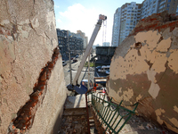 A construction crane is visible behind a flight of stairs inside a building that is being damaged by Russian shelling in Kharkiv, northeaste...