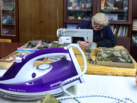 A volunteer is sewing camouflage nets, clothes, and gear for the Ukrainian military at the Combat Toloka Volunteer Centre in Kriukivshchyna,...