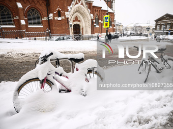 Bicycles on a street covered in snow in Krakow, Poland on December 3rd, 2023. Intense snowfall across Poland has caused major disruptions in...