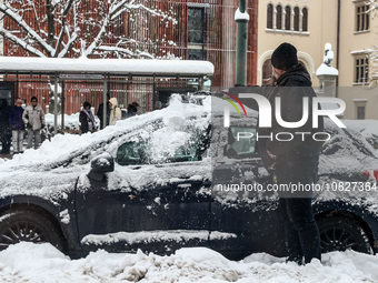 A man sweeping snow off a car in Krakow, Poland on December 3rd, 2023. Intense snowfall across Poland has caused major disruptions in the Le...
