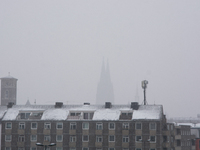 The Dom Cathedral is seen in the background in Cologne, Germany, on December 4, 2023, as snow continues to fall on the city. (