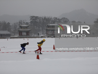 Ice skaters are skating on the ice in the Lake district of Chengde Mountain Resort in Chengde, China, on December 13, 2023. (