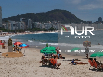 Bathers are moving along Copacabana beach in the south zone of Rio de Janeiro, Brazil, on December 13, 2023. (