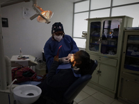 A dentist is performing tests with dental prostheses at the Centro de Odontogeriatria TIII Doctor Guillermo Roman y Carrillo Health Centre i...