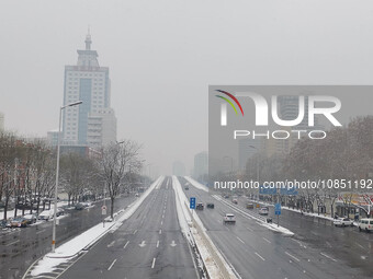 Vehicles are driving in the snow in Beijing, China, on December 13, 2023. (