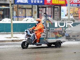 A sanitation worker is seen working during heavy snow in Beijing, China, on December 14, 2023. (