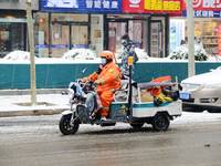 A sanitation worker is seen working during heavy snow in Beijing, China, on December 14, 2023. (
