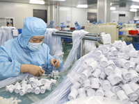 Workers are making medical infusion sets for export in a workshop in Huai'an City, Jiangsu Province, China, on December 14, 2023. (