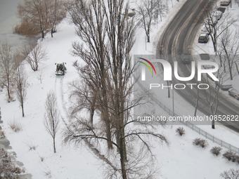 An aerial view is showing a snowy road winding by the river in Kyiv, Ukraine, on December 14, 2023. (