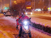 A courier is braving the snow to make a delivery in Beijing, China, on December 14, 2023. (