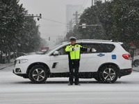 Traffic police are braving the snow to clear traffic in Handan, Hebei Province, China, on December 14, 2023. (