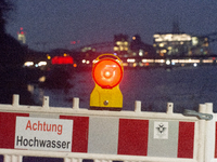 The warning sign for floods is being displayed along the Rhine River during the flooding season in Rondenkirchen, Cologne, Germany, on Decem...