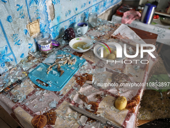 Glass shards are covering the remains of food left on a table in a hostel that is being damaged in a Russian overnight attack in Odesa, sout...