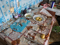 Glass shards are covering the remains of food left on a table in a hostel that is being damaged in a Russian overnight attack in Odesa, sout...