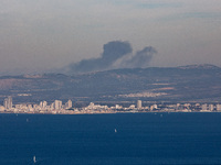 Clouds of smoke are billowing from Israel's northern port city of Haifa on the Mediterranean Coast after an explosion of undetermined origin...