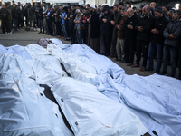 Palestinians are mourning the death of loved ones following an Israeli bombardment in Deir Al-Balah, in the central Gaza Strip, on December...